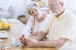 senior couple looking through medications