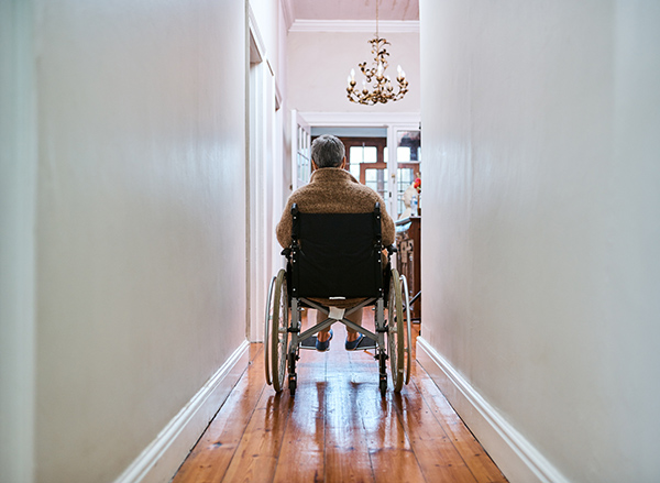 http://carefor.com/wp-content/uploads/2021/08/senior-disabled-man-wheelchair-in-hallway.jpg