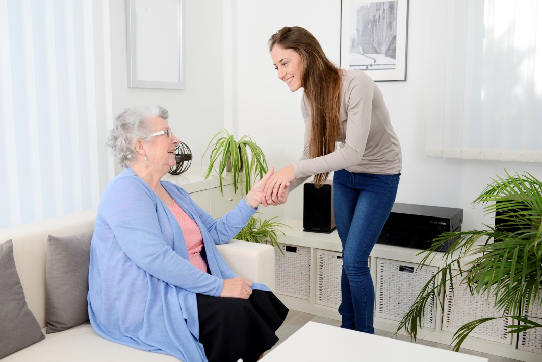 Friendly caregiver meeting a new senior client