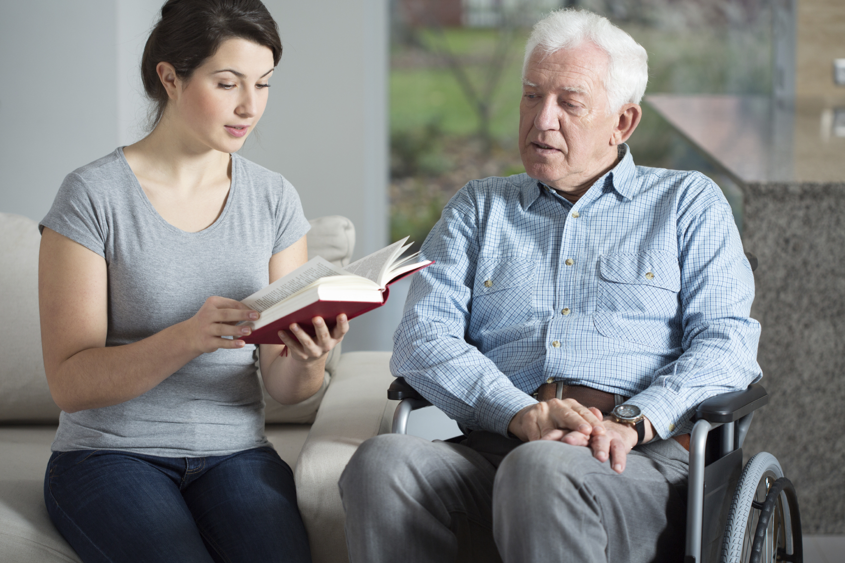 caregiver reading to senior man