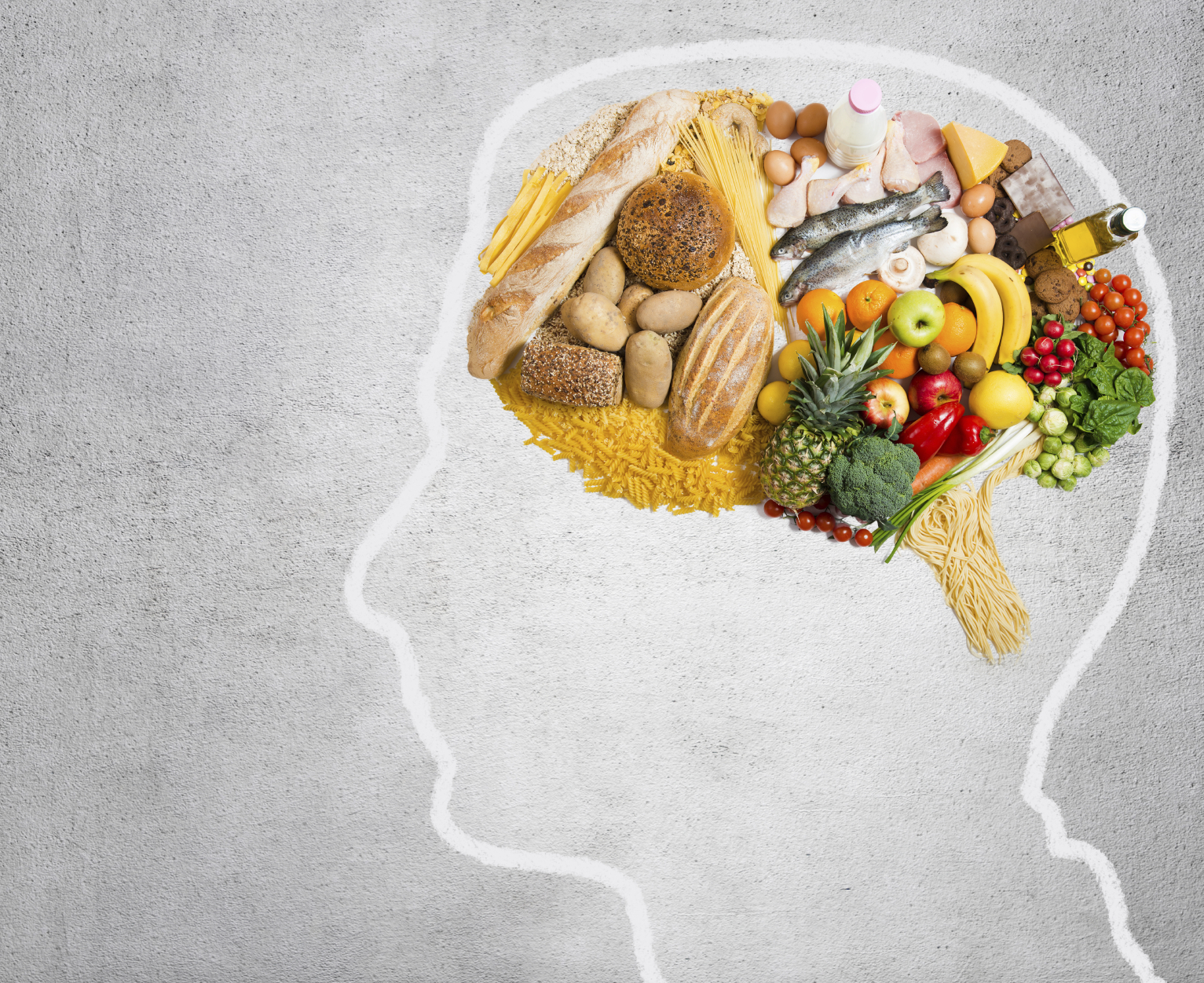 An outline of a brain is filled with colorful, healthy foods, indicating the link between nutrition and dementia.