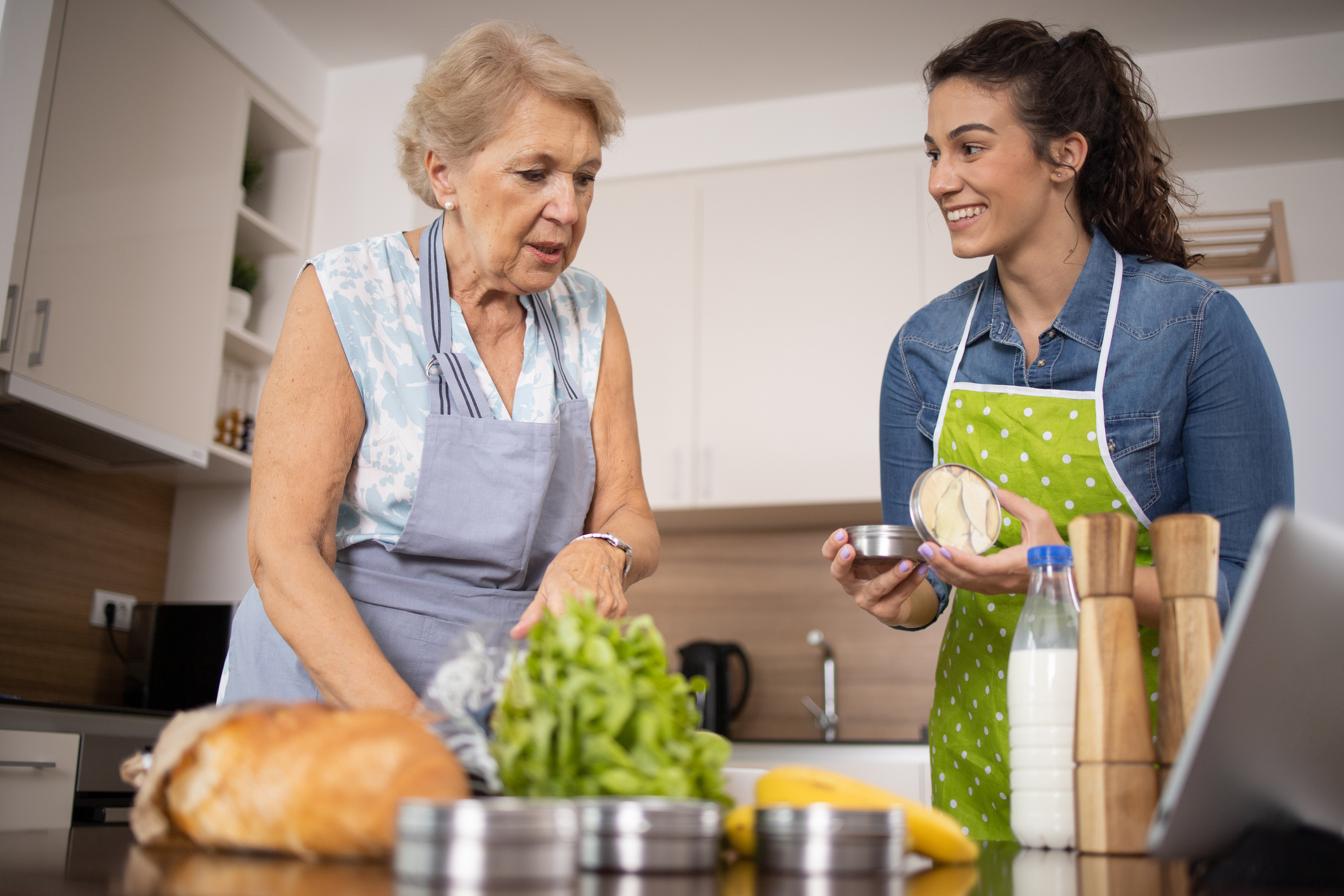 A caregiver provides diabetes care solutions to an older woman at home.