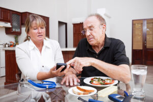 A man receiving diabetes care at home checks his blood sugar level.