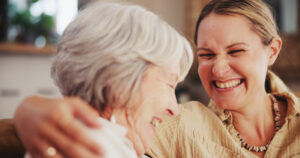 A woman works to support senior emotional health by spending time with a senior loved one.