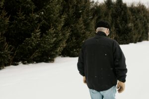 Elderly man walks through winter alone, unsupervised.